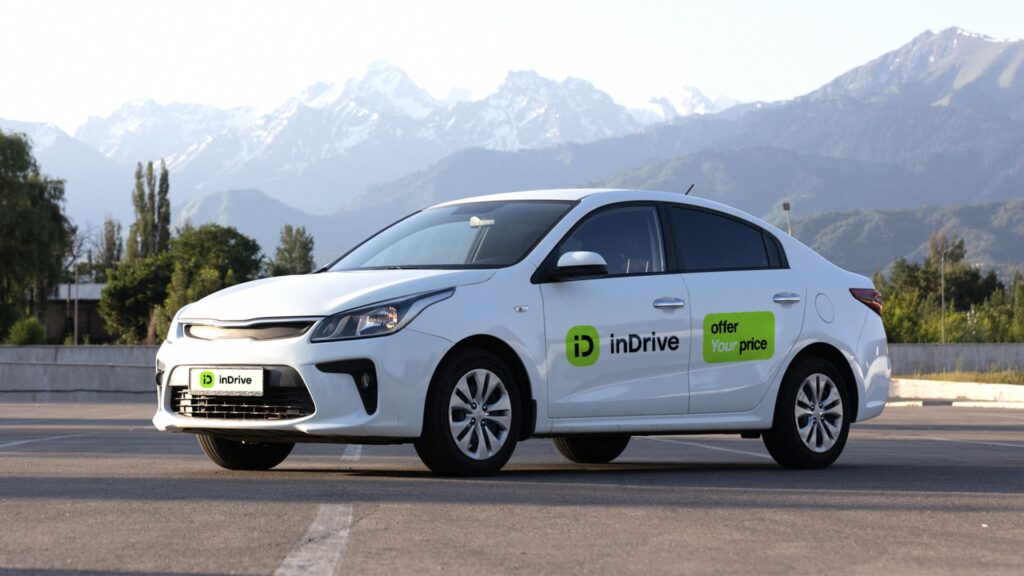 Picture of a branded inDrive vehicle with a mountain view behind